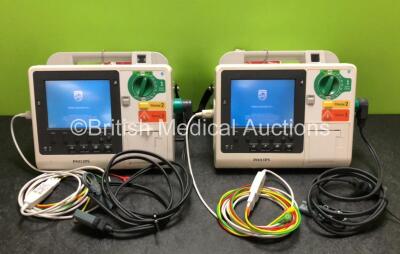 2 x Philips Heartstart XL+ Defibrillators Including ECG and Printer Options with 2 x Philips M1674A 3 Lead ECG Leads, 2 x Philips Batteries Ref 989803167281 and 2 x Paddle Leads (Both Power Up)