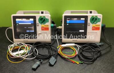 2 x Philips Heartstart XL+ Defibrillators Including ECG and Printer Options with 2 x Philips M1674A 3 Lead ECG Leads, 2 x Philips Batteries Ref 989803167281 and 2 x Paddle Leads (Both Power Up)