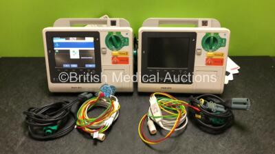 2 x Philips Heartstart XL+ Defibrillators Including ECG and Printer Options with 2 x Philips M1674A 3 Lead ECG Leads, 2 x Philips Batteries Ref 989803167281 and 2 x Paddle Leads (Both Power Up with Stock Battery, 2 x Flat Batteries Included)