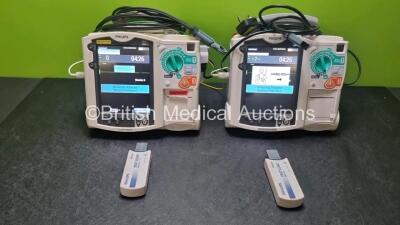 2 x Philips Heartstart MRx Defibrillators Including ,ECG and Printer Options with 2 x Paddle Leads, 2 x Philips M3725A Test Loads, 2 x 3 Lead ECG Leads, 2 x Philips M3538A Batteries and 2 x Philips M3539A Modules (Both Power Up) *SN