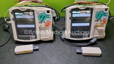 2 x Philips Heartstart MRx Defibrillators Including ,ECG and Printer Options with 2 x Paddle Leads, 2 x Philips M3725A Test Loads, 2 x 3 Lead ECG Leads, 2 x Philips M3538A Batteries and 2 x Philips M3539A Modules (Both Power Up) *SN US000333081 / US009529