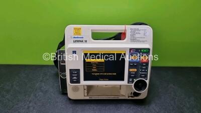 Medtronic Lifepak 12 Physio Control Defibrillator / Monitor Including ECG, SpO2 and Printer Options (Power Up with Stock Battery, Stock Battery Not Included, Damage to Casing and Printer Missing - See Photos, Service Light On)