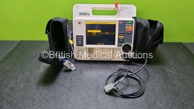 Medtronic Lifepak 12 Physio Control Defibrillator / Monitor Including ECG, SpO2 and Printer Options , 1 x Paddle Lead (Power Up with Stock Battery, Stock Battery Not Included, Damage to Casing and Printer Missing - See Photos, Service Light On)