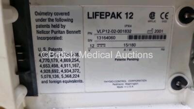 Medtronic Lifepak 12 Physio Control Defibrillator / Monitor Including ECG, SpO2 and Printer Options , 1 x Paddle Lead (Power Up with Stock Battery, Stock Battery Not Included, Damage to Casing and Printer Missing - See Photos, Service Light On) - 6