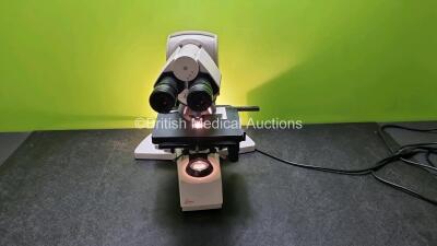 Leica DMLB Type 020-519.010 Benchtop Microscope with 2 x HC Plan s 10 x / 22 Eyepiece, 5 x Leica Optics Including 1 x 2.5, 1 x N Plan / 0.12, 1 x N Plan 10 x / 0.25, 1 x N Plan 20 x / 0.4, 1 x 40 x / 0.65 (Powers Up with Good Bulb, Light Box Broken - See