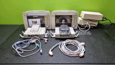 2 x Drager Infinity Delta Patient Monitors Including HemoMed 1, Aux/Hemo 3, MultiMed and NIBP Options (Both Power Up) with, 2 x Drager Infinity Docking Stations (Both with Damage to Casing) 2 x Power Supplies and Patient Monitoring Cables