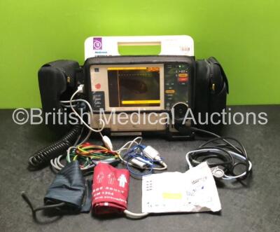 Medtronic Lifepak 12 Physio Control Defibrillator / Monitor Including ECG, SpO2, NIBP and Printer Options with 2 x Batteries, 1 x Paddle Lead, 1 x 4 Lead ECG Lead, 1 x SpO2 Finger Sensor Lead (Damage to Cable - See Photos) and 1 x Skintact Electrodes Pack