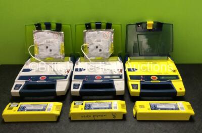 3 x Cardiac Science Powerheart AED G3 Defibrillators with 6 x Batteries and 2 x Electrode Packs *Both Expired* (All Power Up, 1 x Faulty Screen - 3 x in Photo, 3 x in Defibrillators)