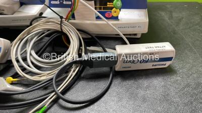 4 x Philips Heartstart XL Defibrillators Including ECG and Printer Options with 4 x Paddle Leads, 4 x Philips M3725A Test Loads and 4 x 3 Lead ECG Leads (All Power Up) *SN US00601964, US00116956, US00601961, US00116953* - 4