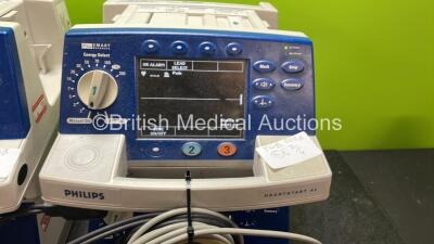 4 x Philips Heartstart XL Defibrillators Including ECG and Printer Options with 4 x Paddle Leads, 4 x Philips M3725A Test Loads and 4 x 3 Lead ECG Leads (All Power Up) *SN US00458261, US00468747, US00578464, US00595806* - 3