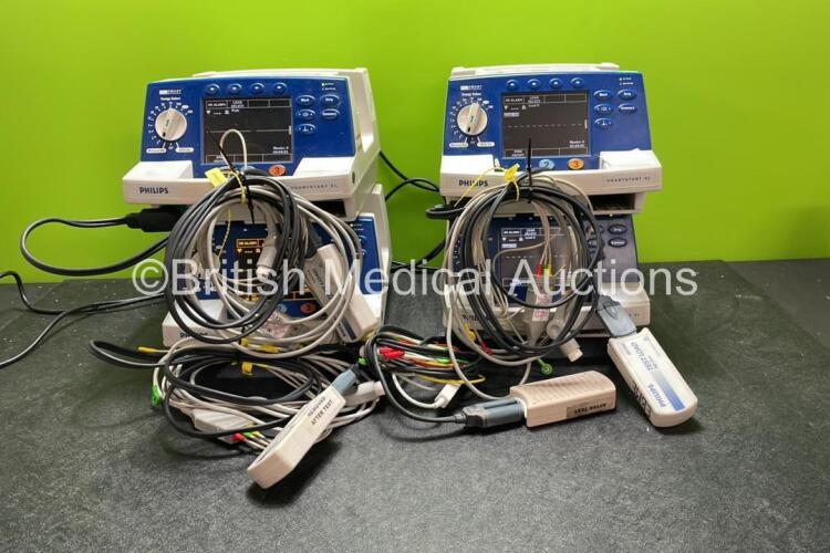 4 x Philips Heartstart XL Defibrillators Including ECG and Printer Options with 4 x Paddle Leads, 4 x Philips M3725A Test Loads and 4 x 3 Lead ECG Leads (All Power Up) *SN US00589288, US00124454, US00583000, US00578468*