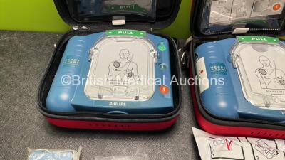 2 x Philips Heartstart HS1 Defibrillators with 4 x Batteries and 4 x Philips REF M5071A Defibrillator Pads *2 Unused* in Carry Cases (Both Power Up) - 2