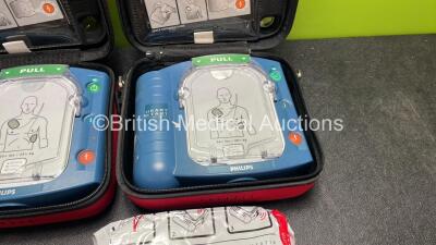 2 x Philips Heartstart HS1 Defibrillators with 4 x Batteries and 4 x Philips REF M5071A Defibrillator Pads *2 Unused* in Carry Cases (Both Power Up) - 3