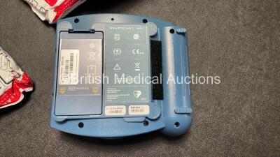 2 x Philips Heartstart HS1 Defibrillators with 4 x Batteries and 4 x Philips REF M5071A Defibrillator Pads *2 Unused* in Carry Cases (Both Power Up) - 6