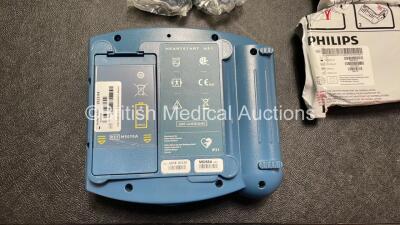 2 x Philips Heartstart HS1 Defibrillators with 3 x Batteries and 4 x Philips REF M5071A Defibrillator Pads *2 Unused* in Carry Cases (Both Power Up) - 6