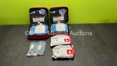 2 x Philips Heartstart HS1 Defibrillators with 4 x Batteries and 4 x Philips REF M5071A Defibrillator Pads *2 Unused* in Carry Cases (Both Power Up)