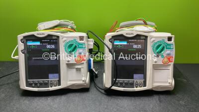 2 x Philips Heartstart MRx Defibrillators Including ECG and Printer Options with 2 x Paddle Leads, 2 x 3 Lead ECG Leads, 2 x Philips M3725A Test Loads and 2 x Philips M3539A Modules (Both Power Up)