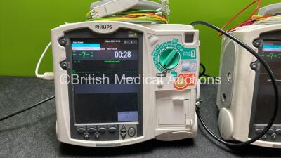 2 x Philips Heartstart MRx Defibrillators Including ECG and Printer Options with 2 x Paddle Leads, 2 x 3 Lead ECG Leads, 2 x Philips M3725A Test Loads and 2 x Philips M3539A Modules (Both Power Up) - 2