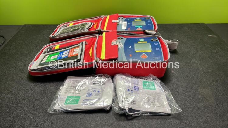 2 x Laerdal Heartstart FR2+ Defibrillators with 2 x Philips M3863A Batteries *Install Dates 08-2020, 07-2018* 2 x Skintact Electrodes in Carry Bags (Both Power Up and Pass Self Tests) *SN 1207264503, 0307227373**