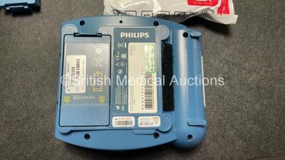 2 x Philips Heartstart HS1 Defibrillators with 4 x Batteries and 4 x Philips REF M5071A Defibrillator Pads *2 Unused* in Carry Cases (Both Power Up) - 5