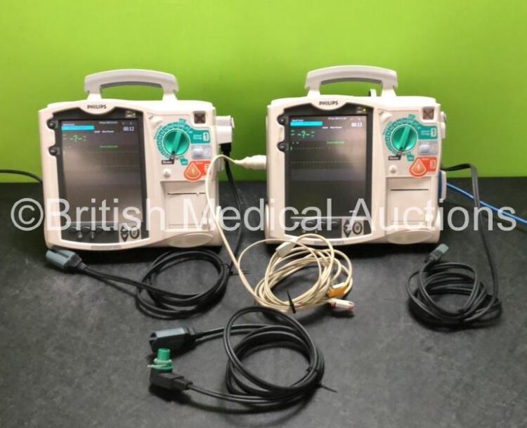 2 x Philips Heartstart MRx Defibrillators / Monitors Including ECG and Printer Options with 3 x Paddle Leads, 2 x Philips M3725A Test Loads, 2 x ECG Lead Connectors and 2 x Philips M3539A Modules (Both Power Up)