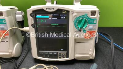 2 x Philips Heartstart MRx Defibrillators / Monitors Including ECG and Printer Options with 3 x Paddle Leads, 2 x Philips M3725A Test Loads, 2 x ECG Lead Connectors and 2 x Philips M3539A Modules (Both Power Up) - 3