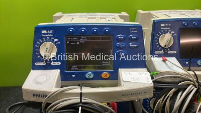 4 x Philips Heartstart XL Defibrillators Including ECG and Printer Options with 4 x Paddle Leads, 4 x Philips M3725A Test Loads and 4 x 3 Lead ECG Leads (All Power Up) *SN US00459432, US005785732, US00578467, US00124453* - 2