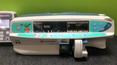 Job Lot Including 2 x Smiths Medical CADD Model 2110 Ambulatory Infusion Pumps with 1 x Power Supply and 2 x Pole Mount Adapters (Both Power Up) and 1 x CareFusion Alaris PK Syringe Pump (Powers Up with Faulty Screen - See Photos) *SN 1066778 / 1066574 / - 4