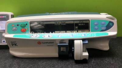 Job Lot Including 2 x Smiths Medical CADD Model 2110 Ambulatory Infusion Pumps with 1 x Power Supply and 2 x Pole Mount Adapters (Both Power Up) and 1 x CareFusion Alaris PK Syringe Pump (Powers Up with Faulty Screen - See Photos) *SN 1066778 / 1066574 / - 5