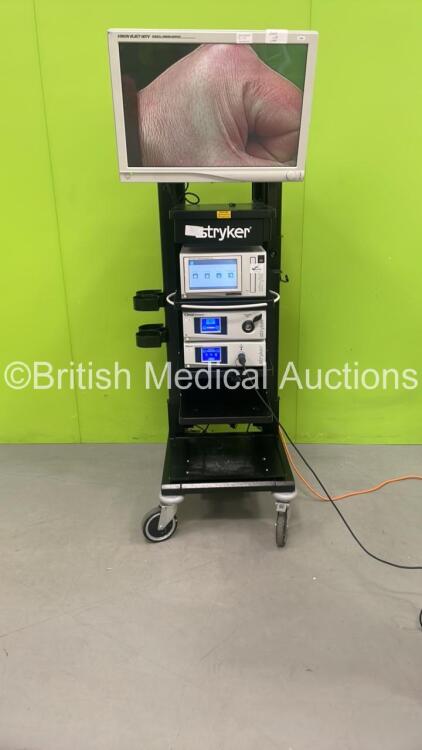 Stryker Stack Trolley with Stryker Vision Elect HDTV Surgical Viewing Monitor, Stryker SDC Ultra HD Information Management System, Stryker L9000 LED Light Source, Stryker 1288HD High Definition Camera Control Unit and Stryker 1288HD Camera Head (Powers Up