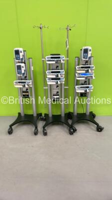 3 x Alaris Docking Stations on Stand with 7 x Syringe Pumps and 3 x Infusion Pumps *SN 135154807, DS800802384, DS800802575*