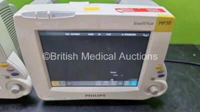 Job Lot Including 2 x Philips IntelliVue MP30 Patient Monitors (Both Power Up) and 2 x IntelliVue X2 Handheld Patient Monitors Including ECG, SpO2, NBP, Press and Temp Options (Both Power Up 1 x with Damage to Casing - See Photo) *SN DE315f1138 / DE037582 - 2