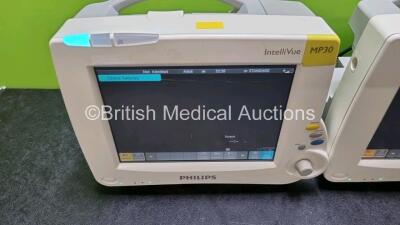 Job Lot Including 2 x IntelliVue MP30 Patient Monitors (Both Power Up Both with Light Scratching on Screen - See Photos) and 2 x IntelliVue X2 Handheld Patient Monitors Including ECG, SpO2, NBP, Press and Temp Options (Both Power Up 1 x with Damage to Cas - 3