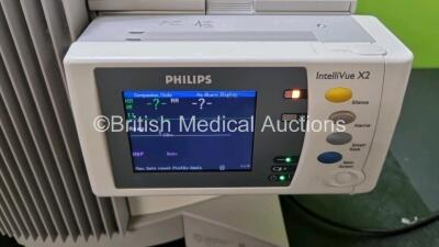 2 x Philips IntelliVue MP70 Patient Monitors (Both Power Up Both with Light Scratching on Screen - See Photo) with 2 x IntelliVue X2 Handheld Patient Monitors Including ECG, SpO2, NBP, Press and Temp Options (Both Power Up 1 x with Slight Damage to Casing - 8