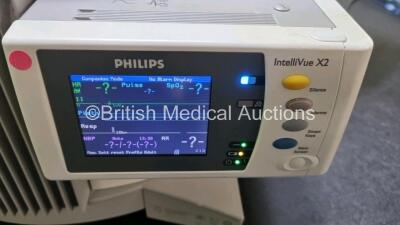 2 x Philips IntelliVue MP70 Patient Monitors (Both Power Up Both with Light Scratching on Screen - See Photo) with 2 x IntelliVue X2 Handheld Patient Monitors Including ECG, SpO2, NBP, Press and Temp Options (Both Power Up 1 x with Slight Damage to Casing - 9