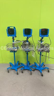 2 x GE Dinamap Carescape V100 Vital Signs Monitors on Stands and 1 x GE Dinamap ProCare Auscultatory Vital Signs Monitor on Stand (All Power Up)