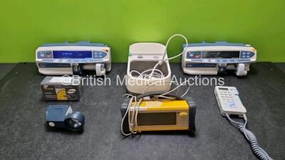 Mixed Lot Including 2 x Carefusion Alaris Plus GH Syringe Pumps (Both Power Up) 1 x Huntleigh FD1 Dopplex Doppler, 1 x Hi Power Aspheric Illuminated Magnifier, 1 x Innospire Deluxe Ventilator (Missing Cover - See Photo) and 1 x Trusat Oximeter *SN 2000042