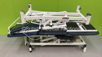 1 x Huntleigh Electric Patient Examination Couch with Controller (Powers Up with Some Damage - See Photo) and 1 x Medi-Plinth Hydraulic Patient Examination Couch (Hydraulics Tested Working) *S/N 584019*