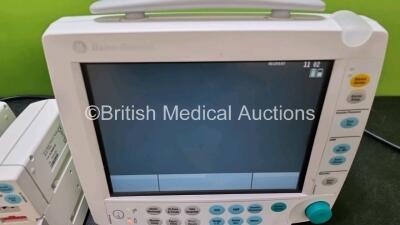 2 x GE Datex Ohmeda FM Patient Monitors (Both Power Up 1 x Missing Light Cover - See Photo) with 2 x GE E-PSMP-00 Modules Including ECG, SpO2, NIBP, T1, T2, P1 and P2 Options *SN 6373064 / 6373105 / 6383803 / 6383804* - 2