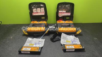 2 x Physio Control Lifepak 1000 Defibrillators with 4 x Batteries and 2 x Electrodes in 2 x Carry Cases (Both Power Up)