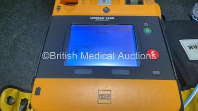 2 x Physio Control Lifepak 1000 Defibrillators with 4 x Batteries and 2 x Electrodes in 2 x Carry Cases (Both Power Up) - 2