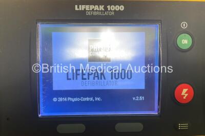 2 x Physio Control Lifepak 1000 Defibrillators with 4 x Batteries and 2 x Electrodes in 2 x Carry Cases (Both Power Up) - 3