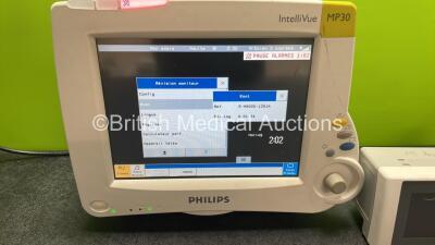 Philips IntelliVue MP30 Patient Monitor with 1 x Philips IntelliVue X2 Handheld Patient Monitor Including ECG, SpO2 and NIBP Options with 1 x Philips M4607A Battery, 1 x Philips M3015A REF 862393 CO2 Microstream Gas Module (Powers Up, Display Language in - 2