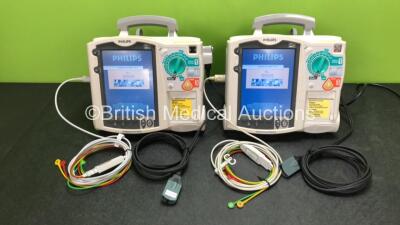 2 x Philips Heartstart MRx Defibrillators Including ECG and Printer Options with 2 x ECG Leads, 2 x Paddle Leads, 2 x Philips M3538A Batteries and 2 x Philips M3539A Modules (Both Power Up) *SN US00324364 / US00326353*