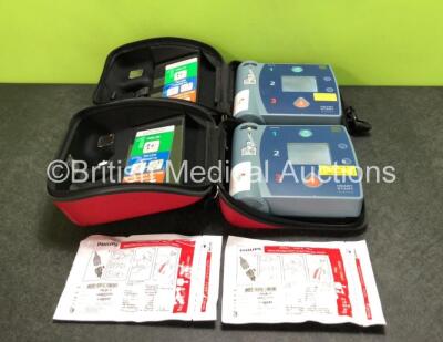 2 x Philips Heartstart FR2+ Defibrillators with 2 x Philips Electrode Pads *Both Expire 2024* and 2 x Batteries in Carry Cases (Both Power Up) *SN 1209308035 / 1111891378*