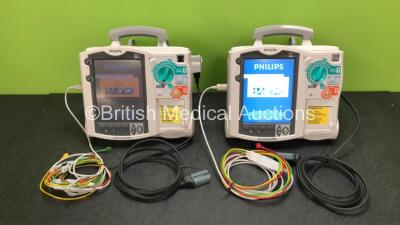 2 x Philips Heartstart MRx Defibrillators Including ECG and Printer Options with 2 x ECG Leads, 2 x Paddle Leads, 2 x Philips M3538A Batteries and 2 x Philips M3539A Modules (Both Power Up) *SN US00330804 / US00570827*