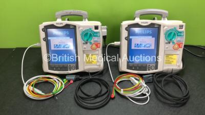 2 x Philips Heartstart MRx Defibrillators Including ECG and Printer Options with 2 x ECG Leads, 2 x Paddle Leads, 2 x Philips M3538A Batteries and 2 x Philips M3539A Modules (Both Power Up) *SN US00324362 / US00324360*