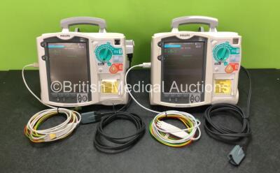 2 x Philips Heartstart MRx Defibrillators Including ECG and Printer Options with 2 x ECG Leads, 2 x Paddle Leads, 2 x Philips M3538A Batteries and 2 x Philips M3539A Modules (Both Power Up) *SN US00331254 / US00330799*