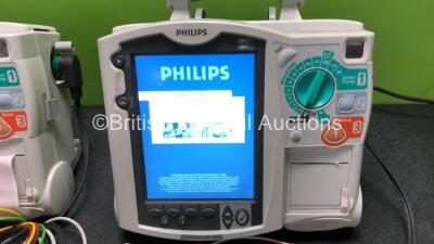 2 x Philips Heartstart MRx Defibrillators Including ECG and Printer Options with 2 x M3725A Test Loads, 2 x Paddle Leads, 2 x ECG Leads, 2 x Batteries and 1 x M33539A Module (Both Power Up then Shut Down - See Photos) - 2