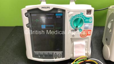 2 x Philips Heartstart MRx Defibrillators Including ECG and Printer Options with 2 x M3725A Test Loads, 2 x Paddle Leads, 2 x ECG Leads, 2 x Batteries and 1 x M33539A Module (Both Power Up then Shut Down - See Photos) - 3